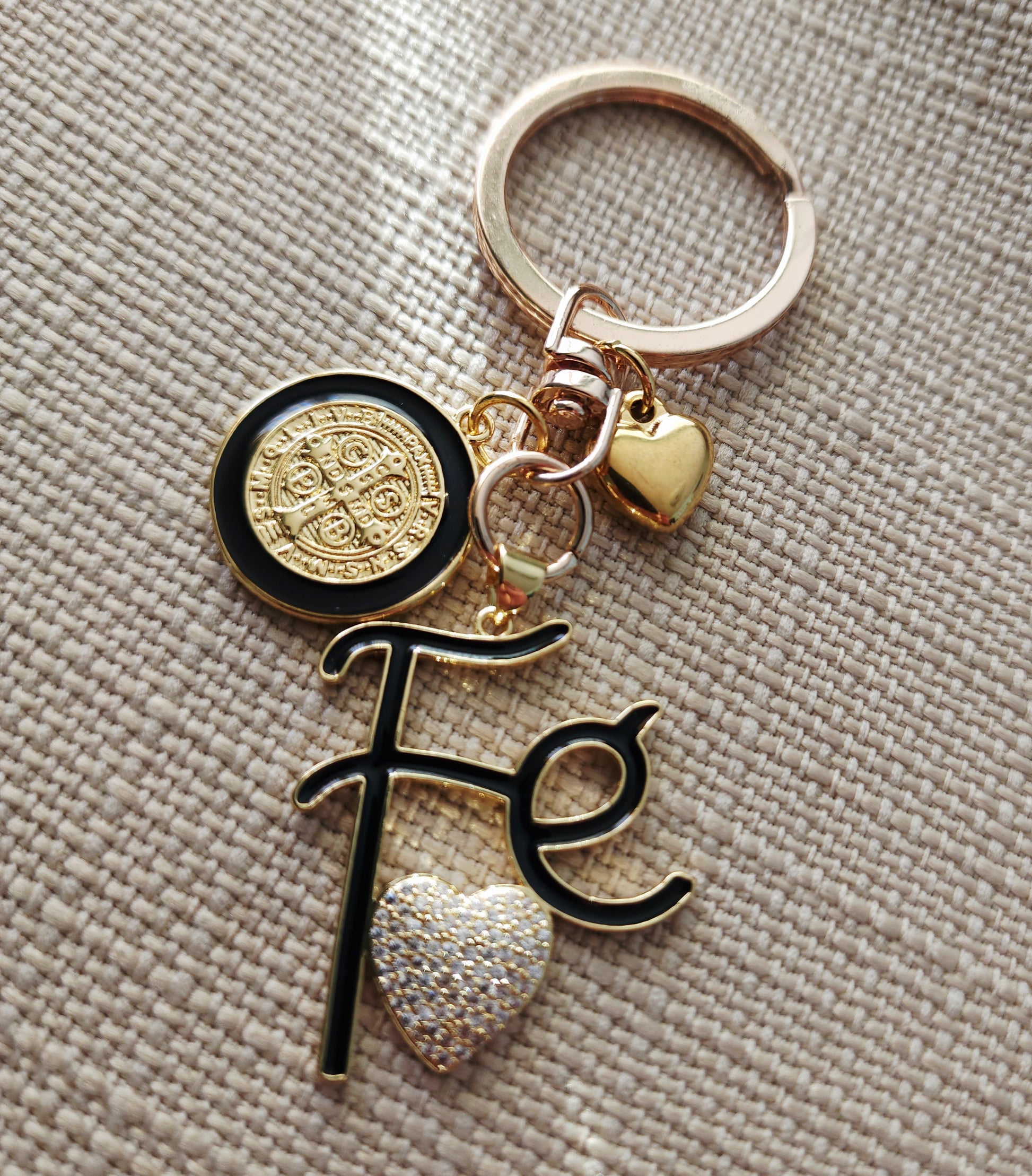 Faith-inspired St. Benedict keychain featuring Fe charm and heart detail, gold plated religious keepsake