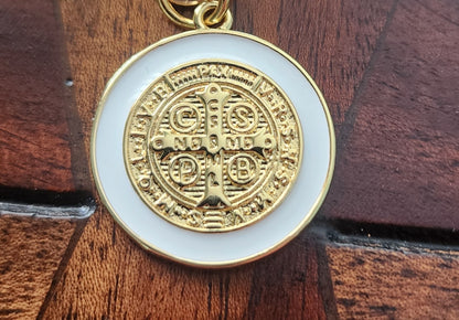 Close-up of St. Benedict medal keychain showing gold plating and textured heart charm