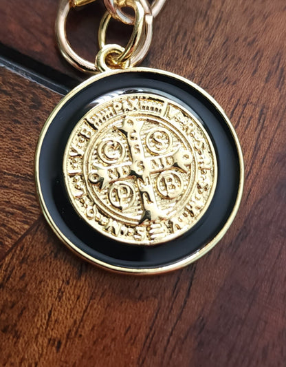 Close-up of St. Benedict medal keychain showing gold plating and textured heart charm