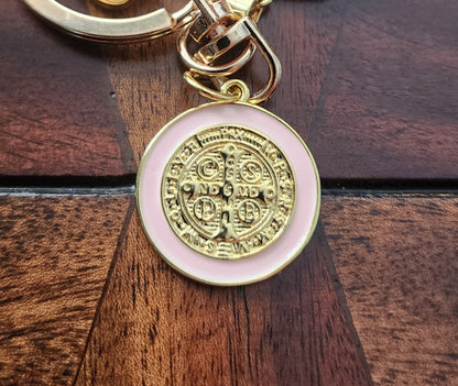 Close-up of St. Benedict medal keychain showing gold plating and textured heart charm
